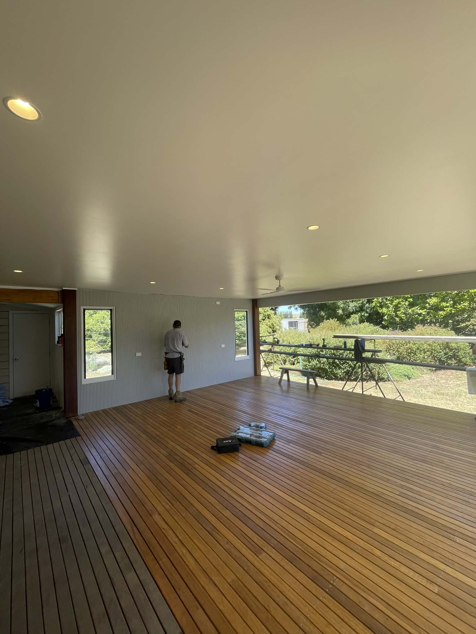 Downlights and a ceiling fan installed in a home's covered outdoor living area